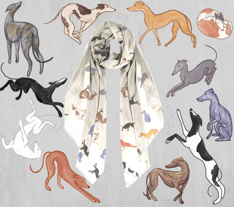 A beige modal scarf with illustrated greyhound dog pattern on it laid out on a grey wooden table with the illustrated greyhounds placed around it.