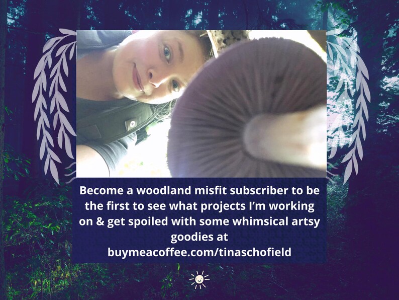 May include: A close-up image features a person and a large mushroom. The mushroom is a muted purple color with a white stem. Text on a blue background reads: "Become a woodland misfit subscriber to be the first to see what projects I'm working on & get spoiled with some whimsical artsy goodies at buymeacoffee.com/tinaschofield."