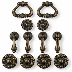 May include: A collection of twelve antique brass-finished metal furniture pulls and knobs. The set includes two large swing handles, two small floral knobs, four drop-style pendant pulls, and four large circular knobs with a twisted rope design.