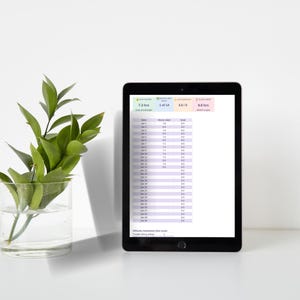 May include: A black tablet displaying a digital sleep tracking spreadsheet with columns for date, hours slept, and goal. The screen shows summary metrics including 7.3 hrs avg falling, 1 of 14 nights met goal, 3.6/5 avg quality, and 9.8 hrs sleep debt.