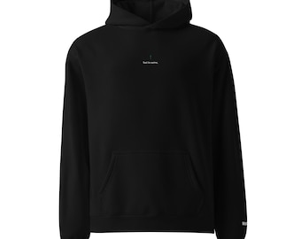 May include: A black long-sleeve hooded sweatshirt featuring a front kangaroo pocket and a small centered graphic on the chest. The graphic consists of a tiny green cross symbol positioned above the white text that reads, "lost to serve."
