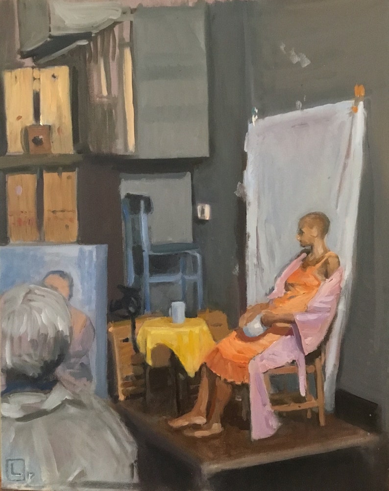 May include: Oil painting depicting a figure in an orange dress and pink robe seated on a wooden chair in an art studio setting.  A yellow tablecloth covers a small table beside the figure.  In the background, there are wooden crates and a partially visible person. The overall palette is muted with earth tones and soft colors.