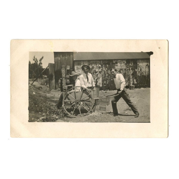 Three Guys Horsing Around RPPC - One Fellow Pushes  Cart for his Two Friends - Divided Real Photo Postcard