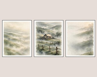 May include: A triptych of three framed watercolour paintings depicting a misty landscape. The left and right panels show rolling green hills in fog, while the centre panel features a small cabin nestled in a valley behind a wooden fence.