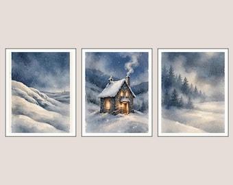 May include: A set of three framed watercolour prints depicting a winter landscape. The left panel shows snow-covered hills, the centre panel features a stone cottage with glowing windows and smoke, and the right panel displays a misty pine forest.