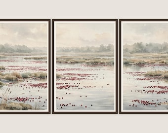 May include: A triptych of three framed watercolour paintings depicting a marshland landscape. The scene features calm water filled with small red floating berries, patches of tan grasses, and a soft, hazy horizon line under a pale sky.