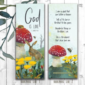 May include: A bookmark featuring a watercolour illustration of a mushroom, a rabbit, and yellow flowers. The text on the bookmark reads "God is Love" and "I John 4:8". The reverse side of the bookmark has a poem about God's love.