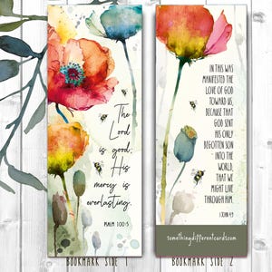 May include: A bookmark with a watercolour floral design featuring poppies and bees. The text on the bookmark reads "The Lord is good; His mercy is everlasting. Psalm 100:5" on one side and "In this was manifested the love of God toward us, because that God sent His only begotten Son into the world, that we might live through Him. 1 John 4:9" on the other side.