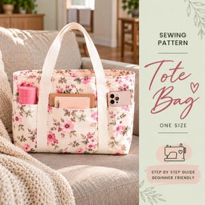 May include: A floral print tote bag with cream-colored handles and three exterior pockets. The bag contains a pink bottle, a notebook, and a smartphone. Text on the right reads: SEWING PATTERN, Tote Bag, ONE SIZE, STEP BY STEP GUIDE.