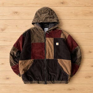 May include: A zip-up hooded jacket featuring a patchwork design of corduroy fabric in shades of brown, dark brown, and burgundy. The jacket includes a front zipper closure, two lower pockets, and a small white rectangular brand logo patch.