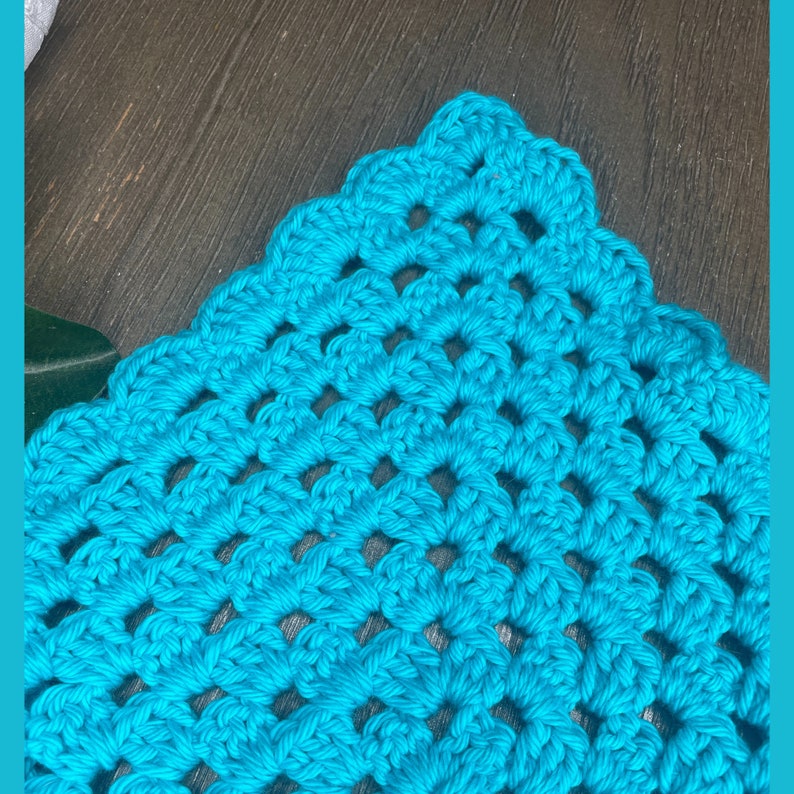 May include: A close-up of a turquoise crocheted square with a diamond pattern.
