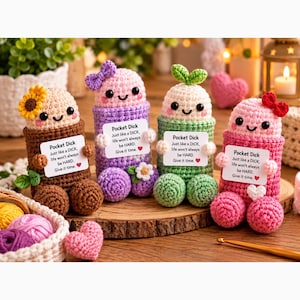 May include: Four crocheted figures in brown, purple, green, and pink, each with a smiling face and holding a white card that reads: Pocket Dick, Just like a DICK, life won't always be HARD. Give it time. Each figure features unique accents like flowers or bows.