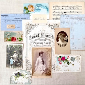 May include: A collection of vintage ephemera including black and white portrait photographs, a sheet music page titled Sweet Memories, handwritten medical bills, floral postcards, and a small note with text, all arranged in a flat lay composition.