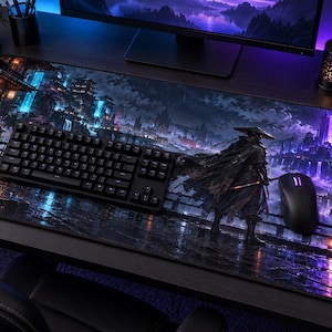 May include: A rectangular desk mat featuring a dark, atmospheric fantasy illustration of a samurai standing on a bridge at night. The scene includes glowing blue and purple architecture, waterfalls, and a full moon, with a black keyboard and mouse.