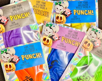 May include: Multiple iridescent foil pouches containing punch balloons in various colors. Each label features cartoon Halloween characters, a pumpkin, and the text: Hope your Halloween really packs a punch! From, Christopher, paperdressevents.com.