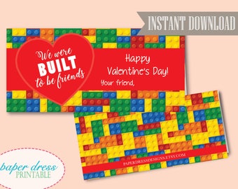 May include: Printable Valentine's Day card featuring a red heart with the text "We were BUILT to be friends" on a background of colorful toy building blocks. The card also includes the text "Happy Valentine's Day! Your friend, PAPERDRESSDESIGNS.ETSY.COM".
