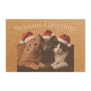 May include: A rectangular tan coir doormat featuring a printed image of three cats wearing red and white Santa hats. The text "Seasons Greetings" is printed in white above the cats, who are an orange tabby, a gray cat, and a black and white cat.