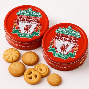 May include: Two round red metal tins featuring the Liverpool Football Club logo with the text You'll Never Walk Alone and Est-1992. One tin is labeled Butter Cookies. Several golden-brown butter cookies in various shapes are arranged nearby.