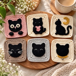May include: A set of six square crochet coasters featuring black cat designs. The coasters are in various colours including pink, cream, tan, and grey. Each square displays a unique cat motif, such as a cat with a heart, a crescent moon, or a bell.