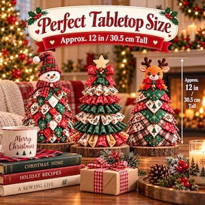 May include: Three fabric Christmas tree decorations, each 12 inches tall, stand on wooden bases. One features a snowman topper, one a star, and one a reindeer. A mug labeled Merry Christmas and stacked books sit nearby.