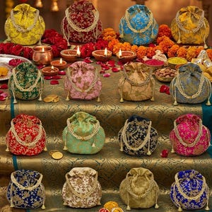 May include: A collection of sixteen drawstring potli bags in various colors including yellow, red, blue, green, pink, and gold, featuring intricate floral embroidery and pearl-beaded handles, with the text PREMIUM QUALITY POTLI PARSES.