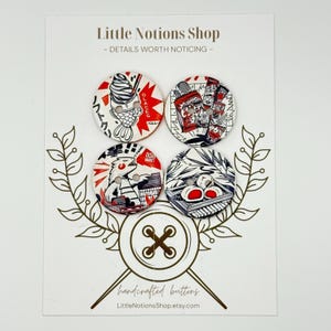 May include: Four circular buttons attached to a display card labeled Little Notions Shop. Each button features a unique graphic design in red, black, and white, including illustrations of ice cream, snacks, a creature, and food items with Japanese text.