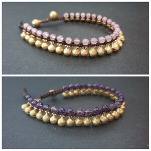 May include: Two anklets with gold beads and a brown cord. One anklet has pink beads and the other has purple beads.