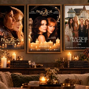 May include: Three framed movie posters for Practical Magic displayed on a wall above a wooden console table. The posters feature portraits of Sandra Bullock and Nicole Kidman, with text including Practical Magic, Practical Magic 2, and 2026.