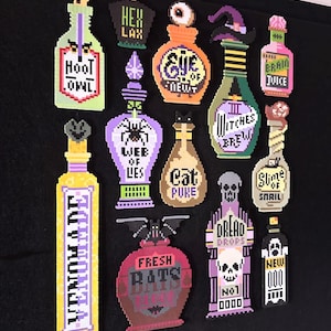 May include: A collection of twelve pixel art potion bottles crafted from fuse beads. The bottles feature various labels including Hoot Owl, Hex Lax, Eye of Newt, Witches Brew, Brain Juice, Web of Lies, Cat Puke, Slime of Snail, Venomade, Fresh Rats, Dread Drops, and New Ooo.