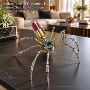 May include: A DIY assembly kit spider model with 90+ parts, measuring 10 x 10 x 3 cm. The spider features gold and silver metallic legs, a green circuit board body, and a clear capsule abdomen filled with small red beads as the main feature.