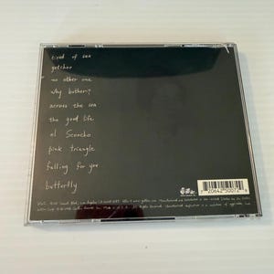 May include: A CD case with a black background and white handwritten song titles. The titles include "tired of sex," "getchoo," "no other one," and "why bother?" The CD case is in a clear plastic jewel case.
