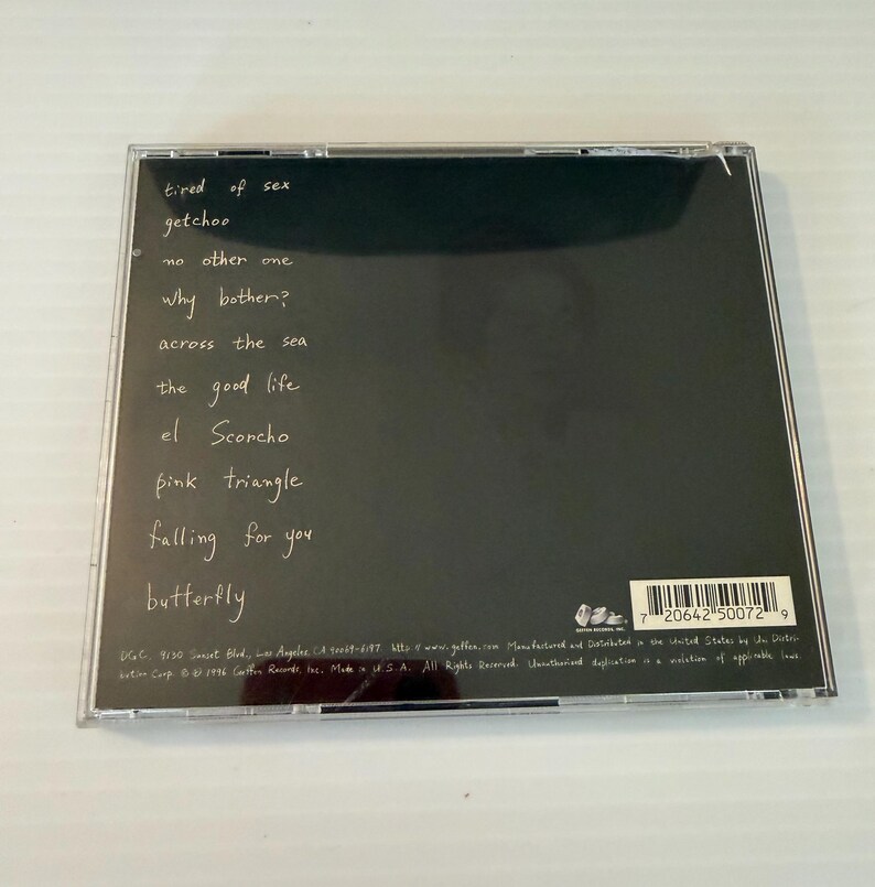 May include: A CD case with a black background and white handwritten song titles. The titles include "tired of sex," "getchoo," "no other one," and "why bother?" The CD case is in a clear plastic jewel case.