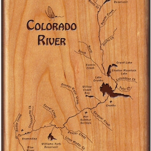 May include: A wooden map of the Colorado River with the text "Colorado River" engraved on the top. The map shows the river's course and various tributaries, including Drowsy Water Creek, Willow Creek, and Beaver Creek. The map also includes the names of several lakes and reservoirs, such as Grand Lake, Shadow Mountain Lake, and Williams Fork Reservoir.