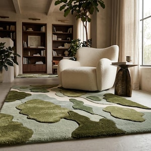 May include: A rectangular area rug featuring an abstract pattern of raised, cloud-like shapes in varying shades of sage, olive, and forest green against a cream-colored background, with a thick, textured pile construction.