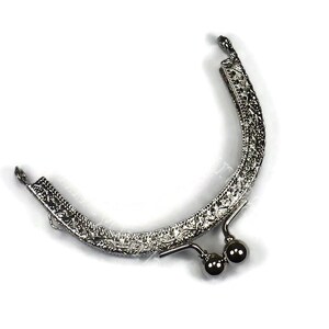 May include: Silver metal purse frame with an ornate design and two round metal clasps.