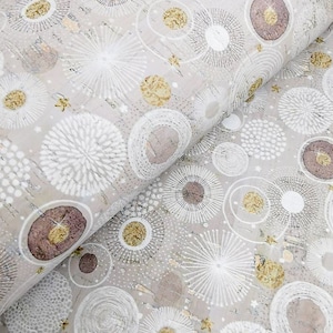 May include: A roll of fabric featuring a repeating pattern of white, gold, and brown circular designs on a light grey background. The circles vary in size and style, some with radiating lines, others with textured centres, and gold accents.