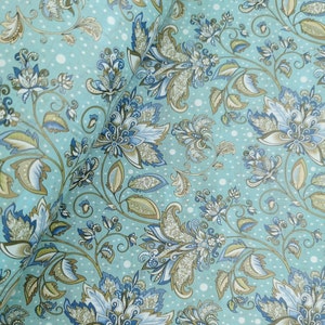 May include: A close-up of a floral pattern on a light blue background. The design features large, stylized flowers in shades of blue, white, and brown, with intricate details. The background has a subtle dotted texture. The overall theme is a vintage floral design.