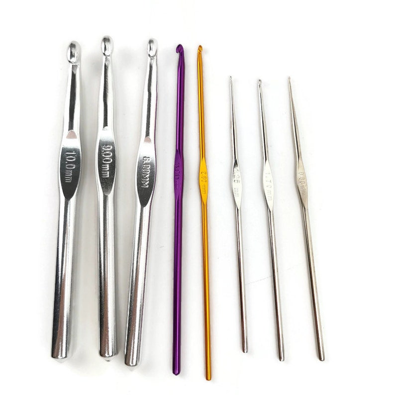 May include: A set of eight crochet hooks in various sizes, including 3.5 mm, 4.0 mm, 5.0 mm, 6.0 mm, 8.0 mm, 9.0 mm, and 10.0 mm. The hooks are made of metal and have a silver, gold, and purple finish.