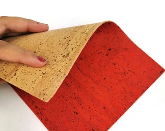 May include: A sheet of cork material with one side a natural cork color and the other side painted red.