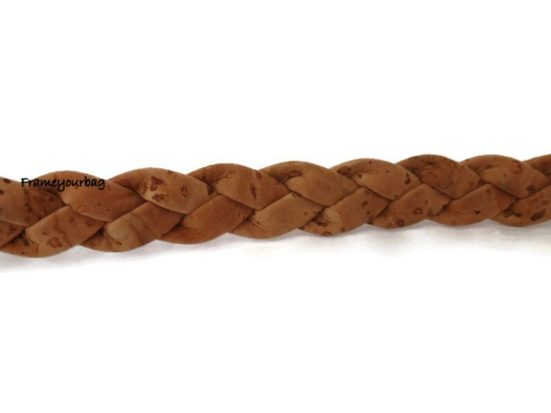 May include: A close-up of a braided cork strap, showing the natural texture and color of the cork.