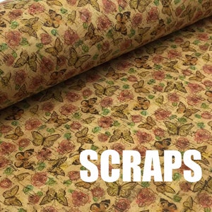 May include: A cork fabric with a repeating pattern of butterflies and roses in shades of pink, brown, and green. The fabric has a vintage look and the word "SCRAPS" is printed in white letters at the bottom of the image.