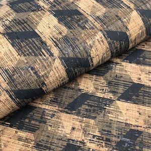 May include: Close-up of a fabric with a black and brown geometric pattern. The fabric has a textured, woven look.