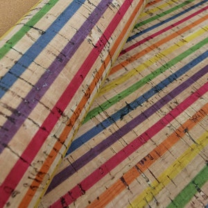 May include: Cork fabric with rainbow coloured stripes. The fabric has a natural cork texture and is perfect for crafting projects.