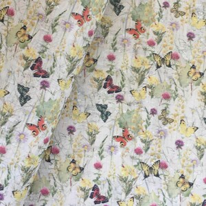 May include: A white background with a repeating pattern of butterflies and flowers. The butterflies are in various colours, including red, orange, yellow, and black. The flowers are in shades of pink, yellow, and green.