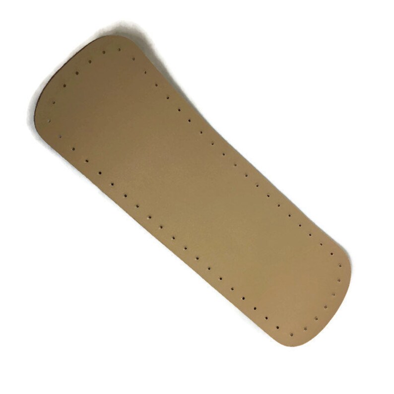Op de afbeelding: Een lichtbruine leren riem met gelijkmatig verdeelde gaten voor het naaien. De riem is aan de uiteinden gebogen.