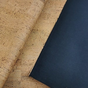 May include: A close-up of a piece of cork fabric with a dark blue fabric underneath.