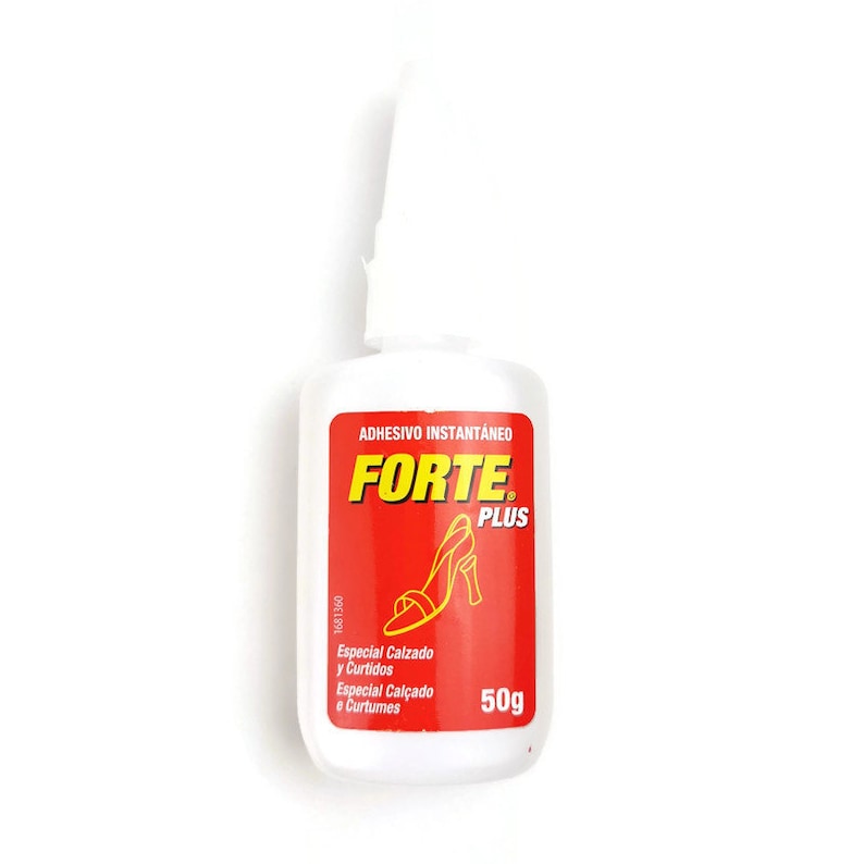 May include: A white bottle of Forte Plus instant adhesive, labelled "Adhesivo Instantaneo Forte Plus". The bottle is 50g and is designed for shoes and leather. The label is red with a yellow logo and a picture of a high heel shoe.