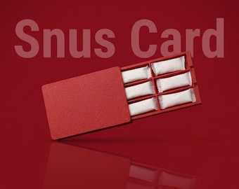 May include: A red rectangular Snus Card case with a textured surface, featuring six white rectangular pouches arranged in two columns of three. The text Snus Card is displayed in large letters above the case and in small text below.