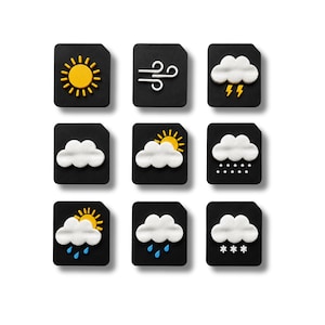 May include: A set of nine square black tiles featuring raised weather icons in white, yellow, and blue. The icons depict a sun, wind, storm, clouds, sun behind a cloud, rain, snow, and various combinations of these elements in a grid layout.