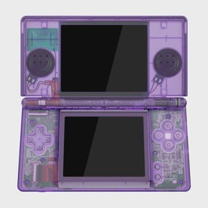 May include: A handheld video game console with a translucent purple plastic shell. The device features a dual-screen layout, a directional pad, four action buttons labeled A, B, X, and Y, and two circular speakers visible through the clear casing.